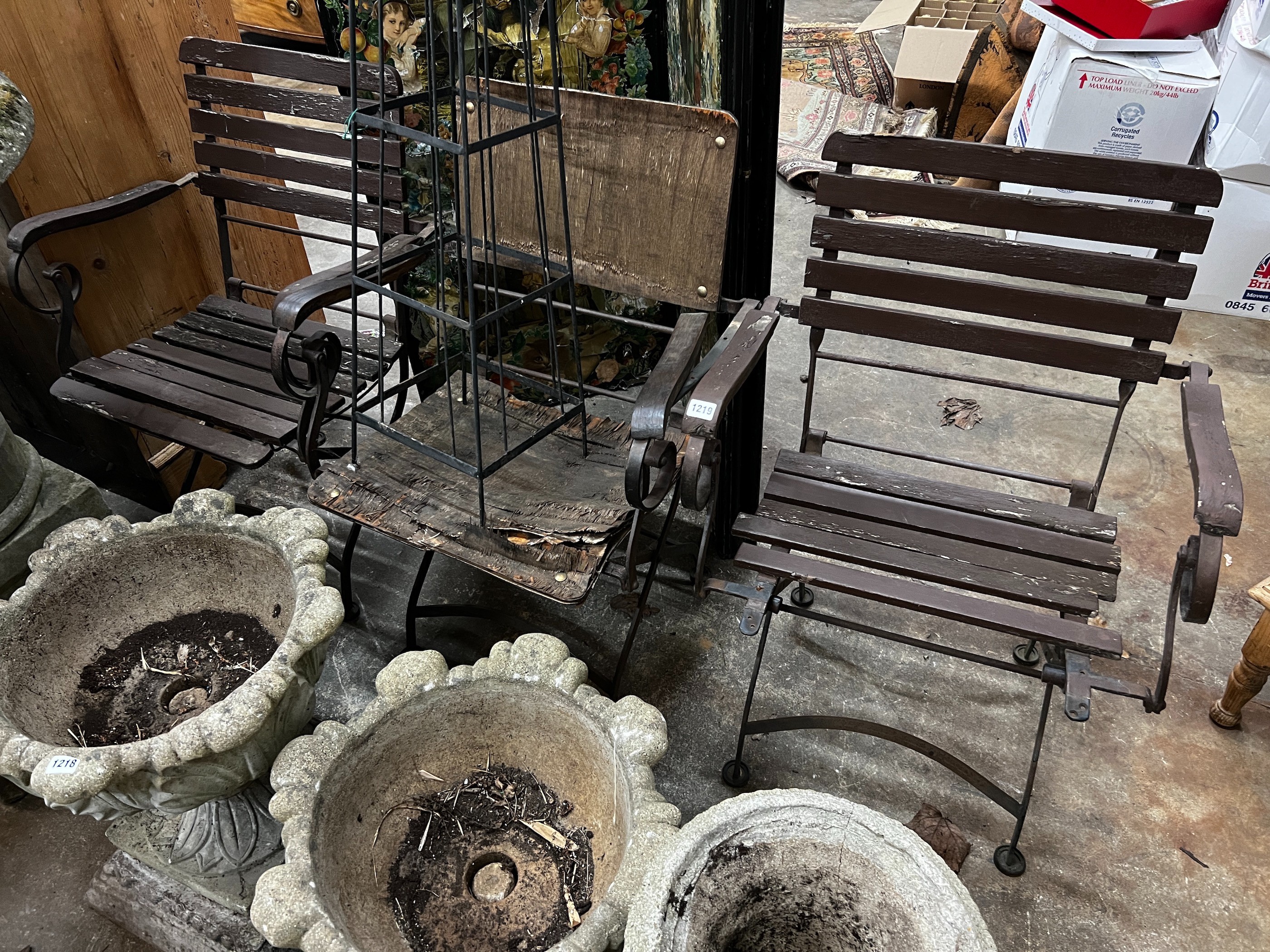A wrought iron garden growing frame, height 130cm together with three wrought iron folding garden chairs